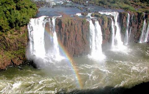 Iguazu Falls: waterfalls plunging over basalt cliffs with a rainbow