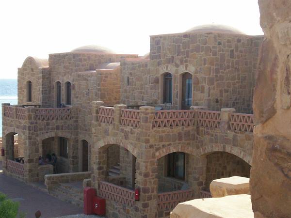 Stone buildings with balconies and domes by the Red Sea