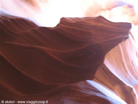 Wavy sandstone walls inside Antelope Canyon, light from above
