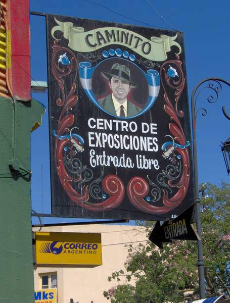 Painted Caminito sign in Buenos Aires, portrait with Argentine flag under blue sky
