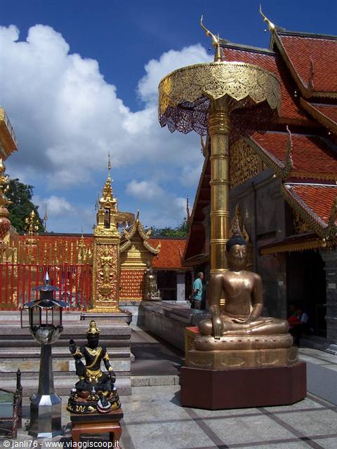 Golden Buddha statue under golden umbrella at Wat Phra That Doi Suthep