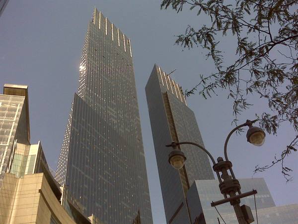 Glass skyscrapers at Columbus Circle, New York, against the sky, street lamp in foreground