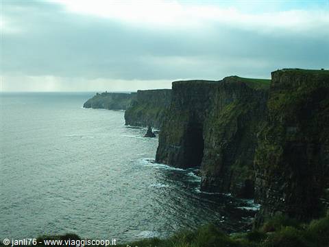 Cliffs of Moher, rocky walls above the ocean under cloudy skies
