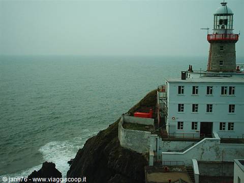Baily Lighthouse at Howth: stone tower on cliffs above the grey sea
