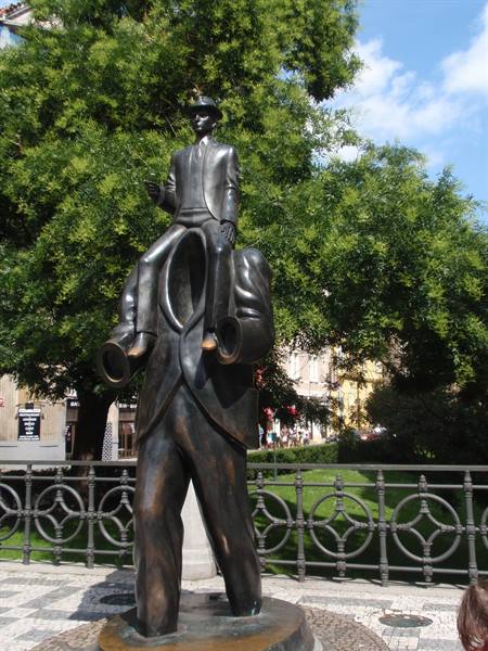 Bronze Kafka statue in Prague: headless suit with seated man on collar