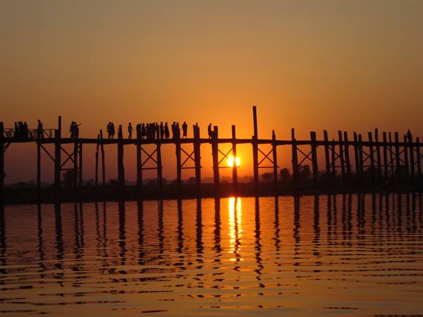 U Bein wooden teak bridge, silhouetted people crossing at sunset