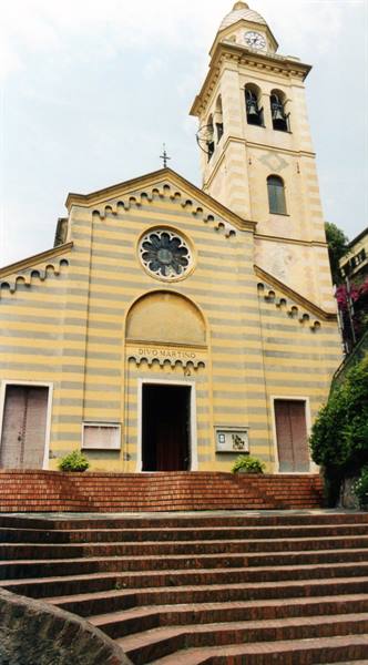 Divo Martino church in Portofino, striped yellow facade, brick staircase leading up