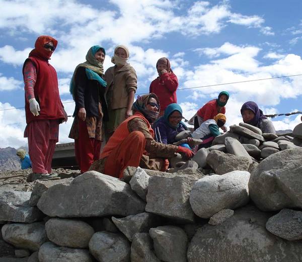 women at work: they clean the hand-stones on the hand-wall at Shey