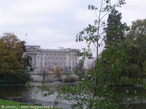 Buckingham Palace seen across the lake in St James's Park among autumn trees