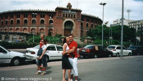 Tourists embrace in front of Barcelona's Monumental bullring