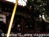 Golden lantern in front of a traditional wooden temple roof