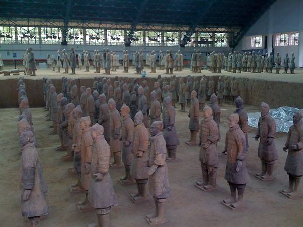 Rows of terracotta warriors inside the covered excavation hall in Xi'an