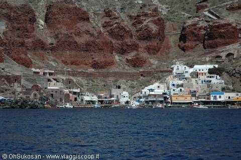 Fishing village with white houses beneath red cliffs, Amoudi Bay, Santorini