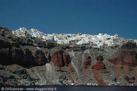 White houses of Oia perched on Santorini's red cliffs