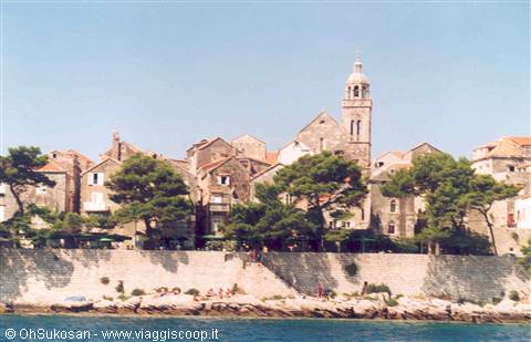 Stone bell tower rising above Korčula old houses by the Adriatic