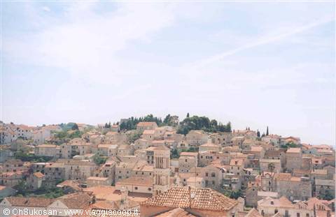 Stone houses and red-tiled rooftops of Dubrovnik old town under a blue sky