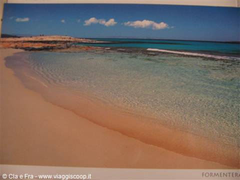 Formentera postcard: pale sand, clear turquoise water and rocky shore