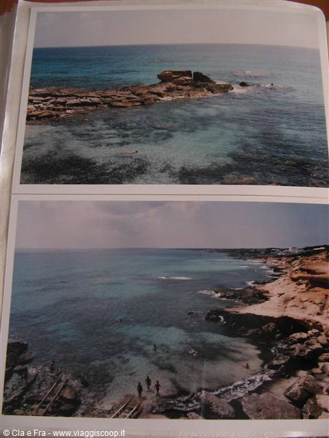 Rocky beach with pale rocks and turquoise water, people swimming
