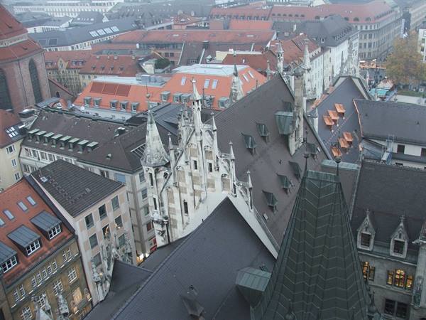 Gothic spires and slate rooftops of Munich's Old Town Hall under grey sky