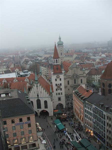 Munich's Altes Rathaus in the fog, red roofs and crowds at Marienplatz