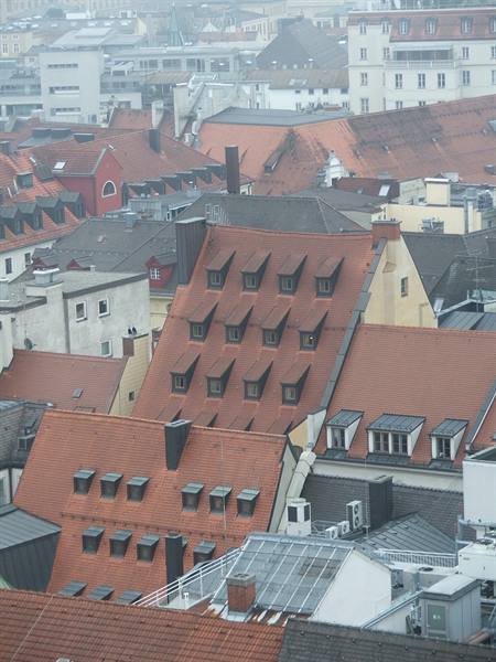 Red tiled rooftops with dormer windows in the fog, Munich
