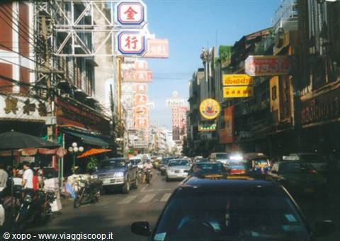 Red and gold Chinese signs over Yaowarat Road, Bangkok traffic and street market