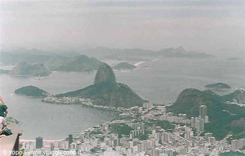 Tourists on the overlook gaze at Sugarloaf Mountain and Rio's bay