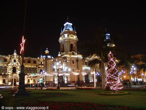 Lima Cathedral lit up at night with a Christmas tree on Plaza Mayor