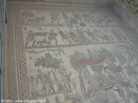Ancient floor mosaic depicting hunting scenes with figures and animals among trees