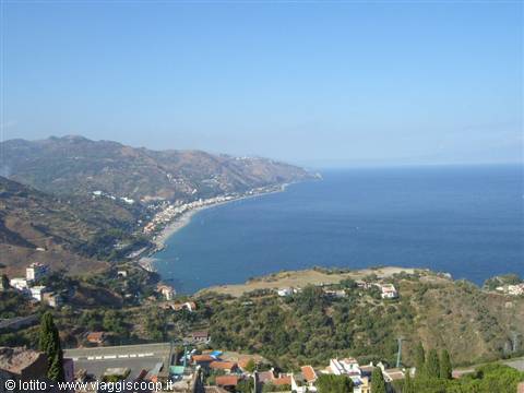 Sandy beach bay with houses and green hills by the blue sea, Giardini Naxos