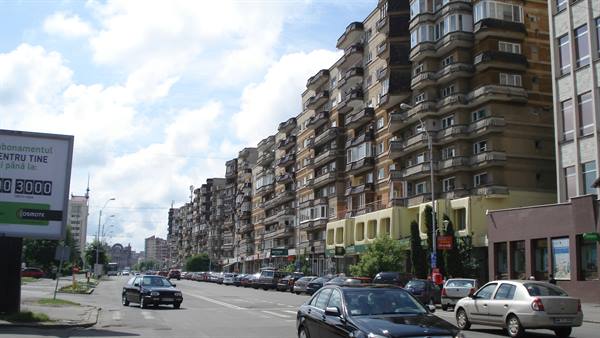 Socialist apartment blocks with balconies along busy avenue in Baia Mare