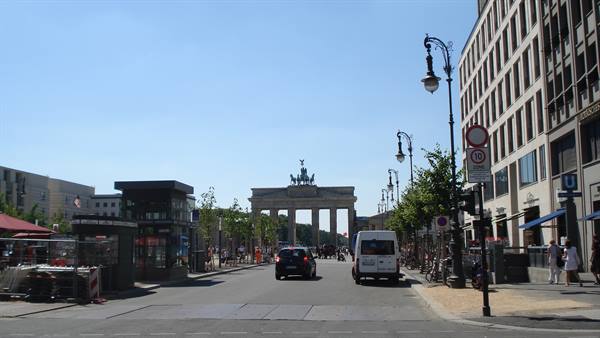Busy street leading to the Brandenburg Gate in sunlight