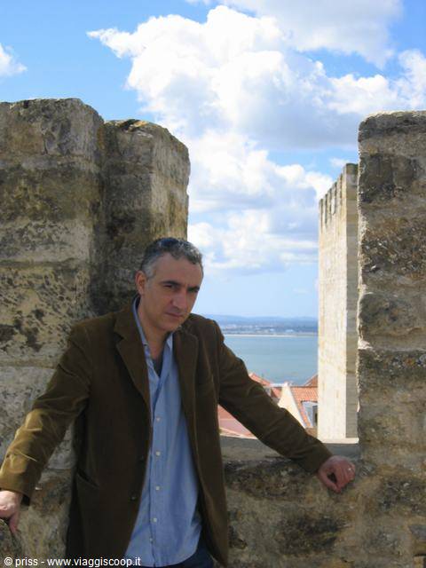 Man leaning on medieval castle walls of São Jorge, Lisbon