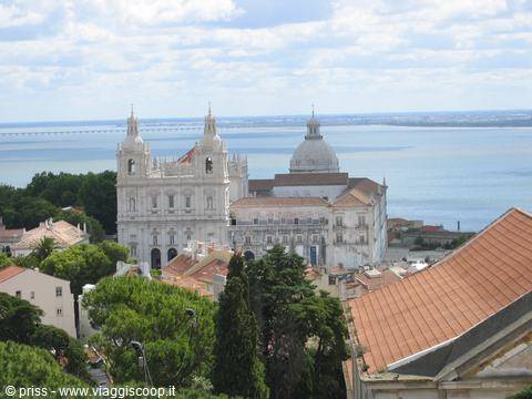 São Vicente de Fora monastery in Lisbon with red rooftops and Tagus river