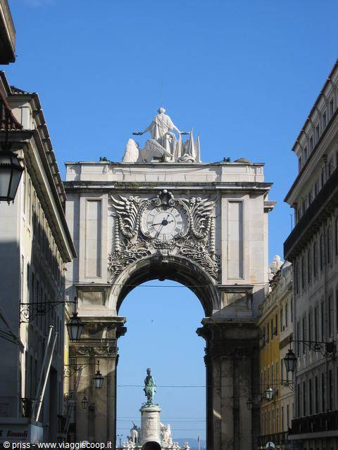 Rua Augusta Arch in Lisbon, stone clock and statues against blue sky