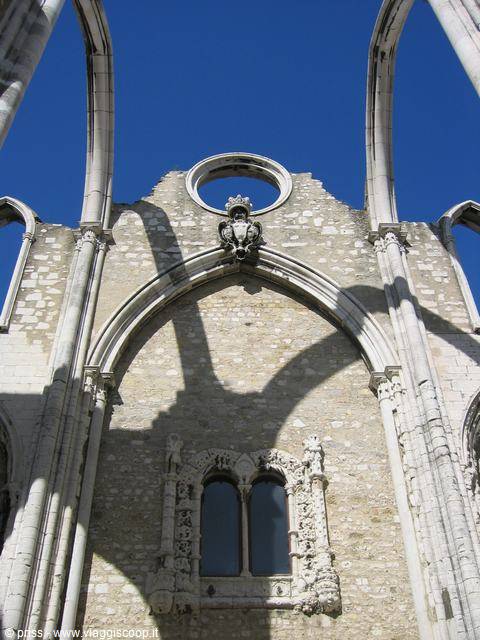 Gothic arches of the Convento do Carmo facade in Lisbon against blue sky