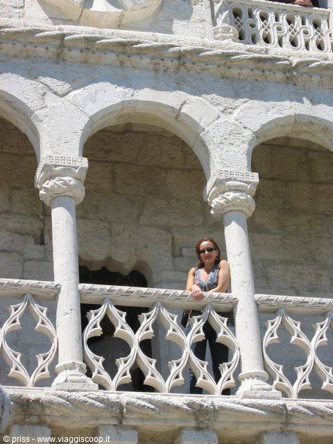 Woman leaning on the stone balcony of Belém Tower, Lisbon
