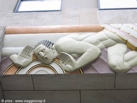 Art deco relief of reclining male figure, white stone, natural light