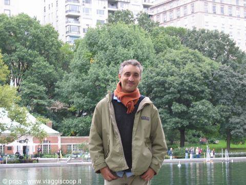 Man in orange scarf by the Central Park pond, New York