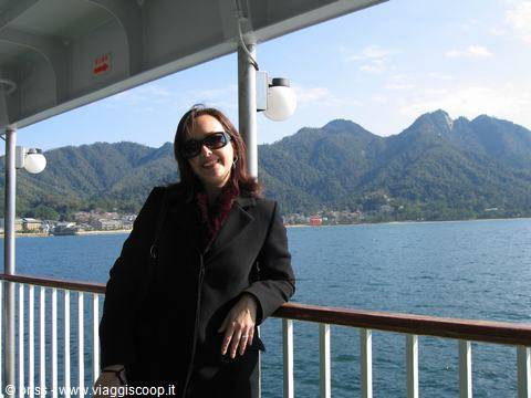 Sul traghetto per Miyajima, sorridente vicino alla ringhiera