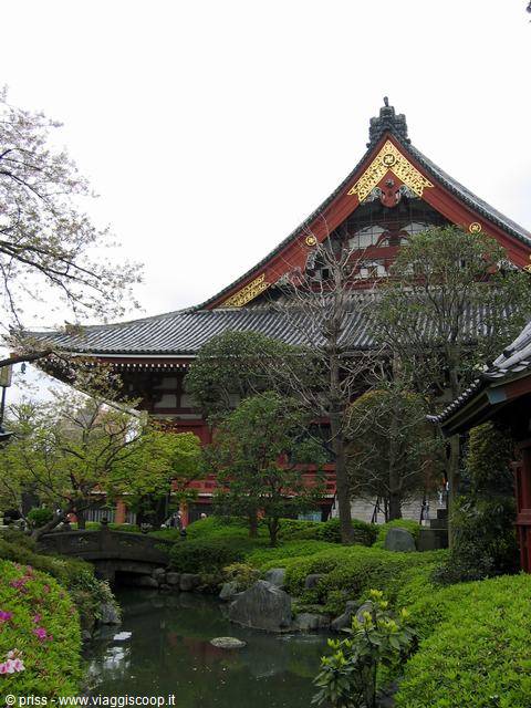 Garden pond and stone bridge in front of Sensō-ji temple