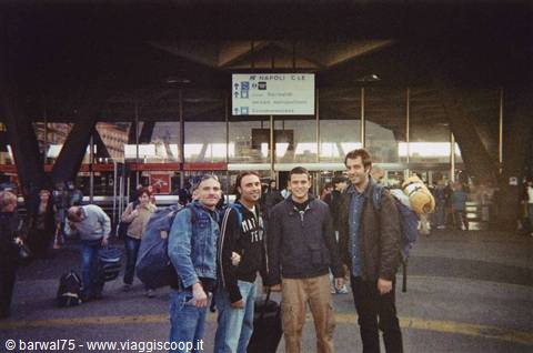 Four backpackers with luggage in front of Napoli Centrale station