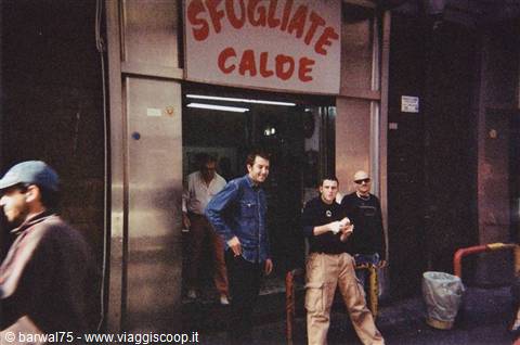 Guys outside a warm sfogliatella shop in Naples