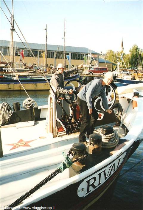 Two people aboard the fishing boat Rival moored at the harbour