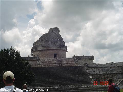 El Caracol observatory at Chichén Itzá, Mayan stone ruins under grey clouds, tourists below