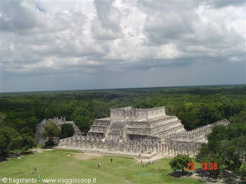 Temple of the Warriors at Chichen Itza, grey stone amid green jungle and clouds