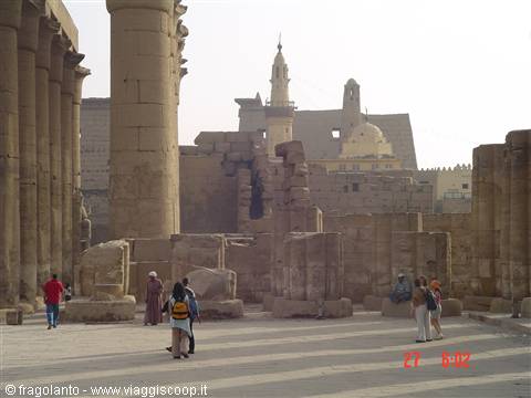 Tourists walk among the stone columns of Karnak Temple in Luxor