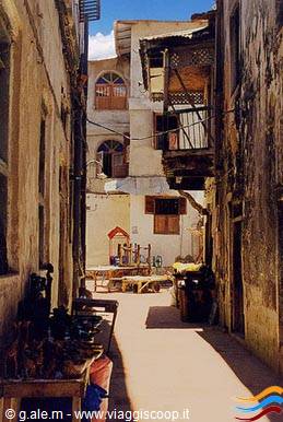 Narrow alley with coral-stone houses and wooden balconies, Stone Town, Zanzibar