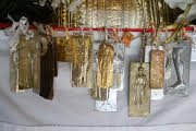 Golden Buddhist amulets hanging together, warm light