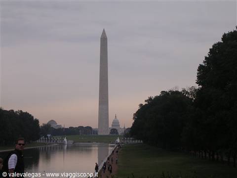Washington Monument reflected in the Reflecting Pool, Capitol dome behind, gray sky